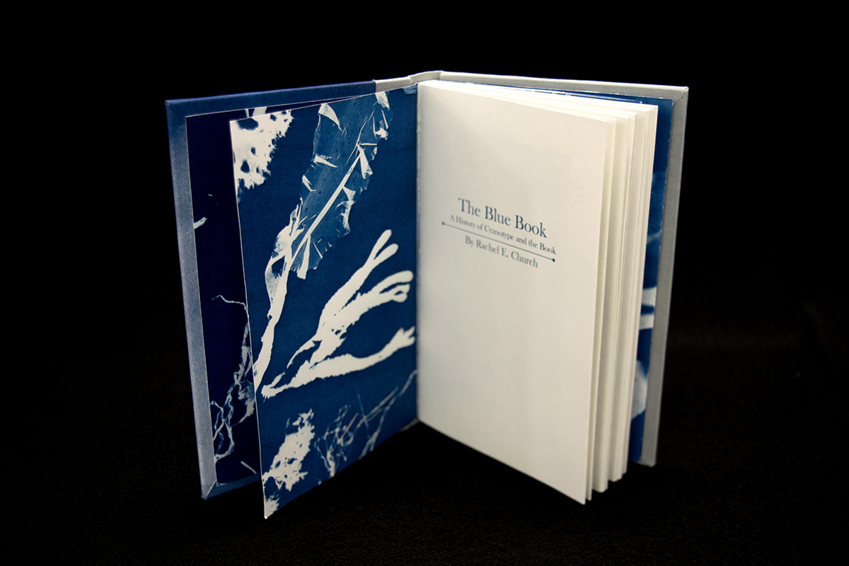 title page of "The Blue Book" showing cyanotype end pages printed with seaweed.