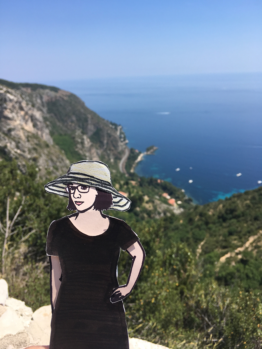 paper doll of the artist in front of French Rivera coastline