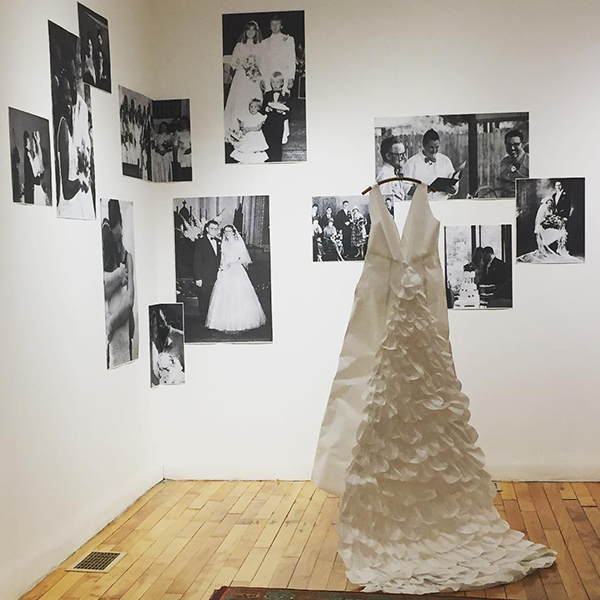 paper wedding dress in front of black and white wedding photos. Link to untitled paper wedding dress.