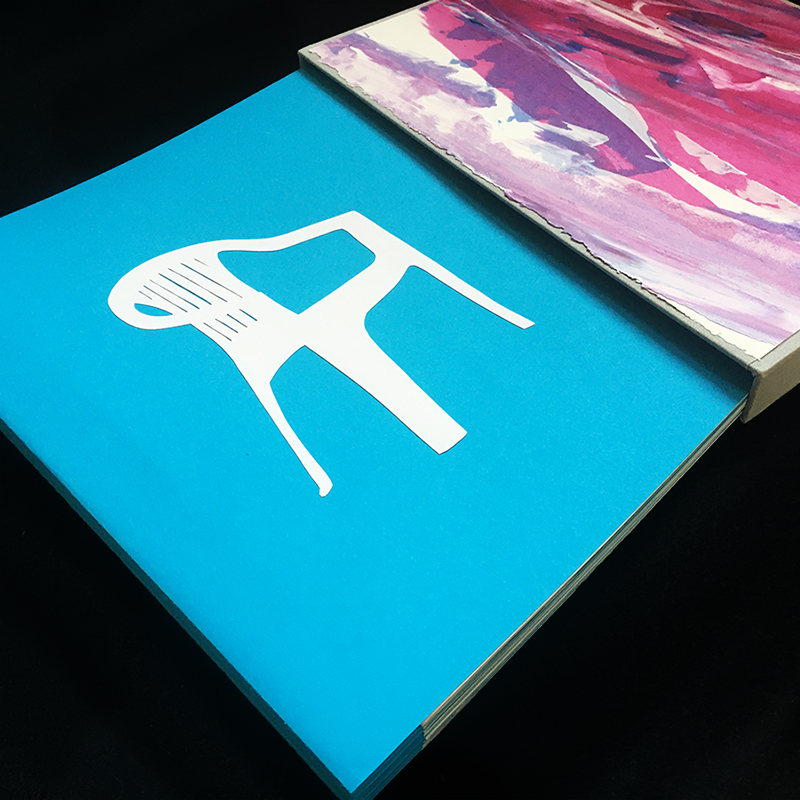 book with image of plastic patio chair on cover, with slipcase. Link to Ile Saint-Honorat.