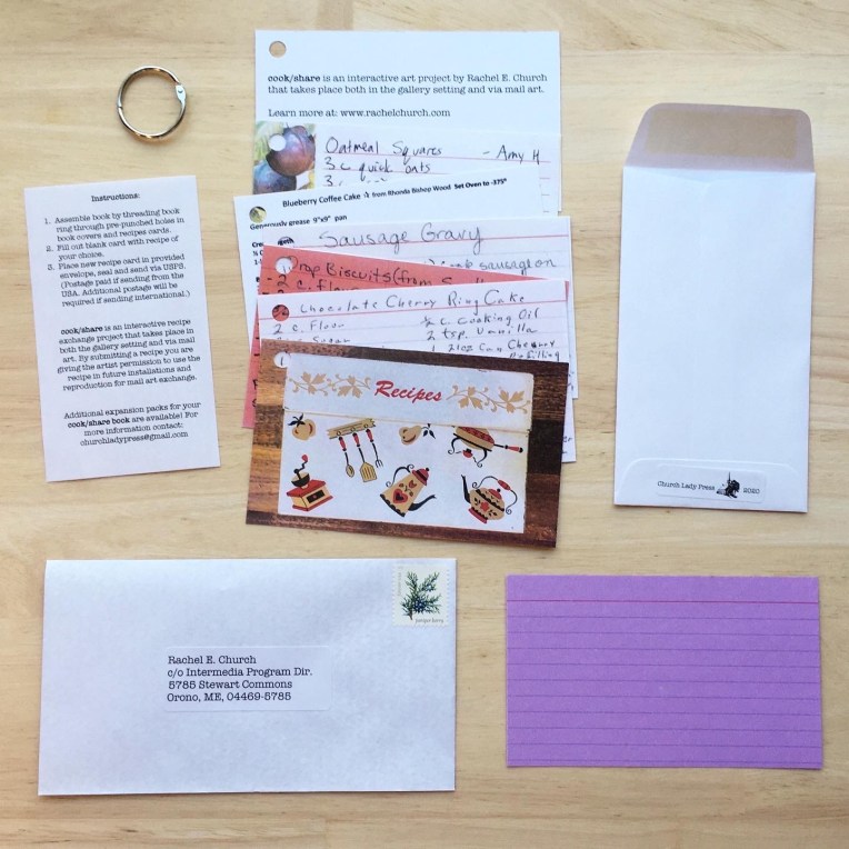 5 recipe card with hole punched in top left corner. 1 front cover with hold punch in top left corner showing image of recipe box. 1 back cover with hole punch in top left corner. 1 small piece of paper with instructions. 1 book ring. 1 blank recipe card. 1 postage-paid addressed envelope. One small open envelope which reads "Church Lady Press. 2020." 