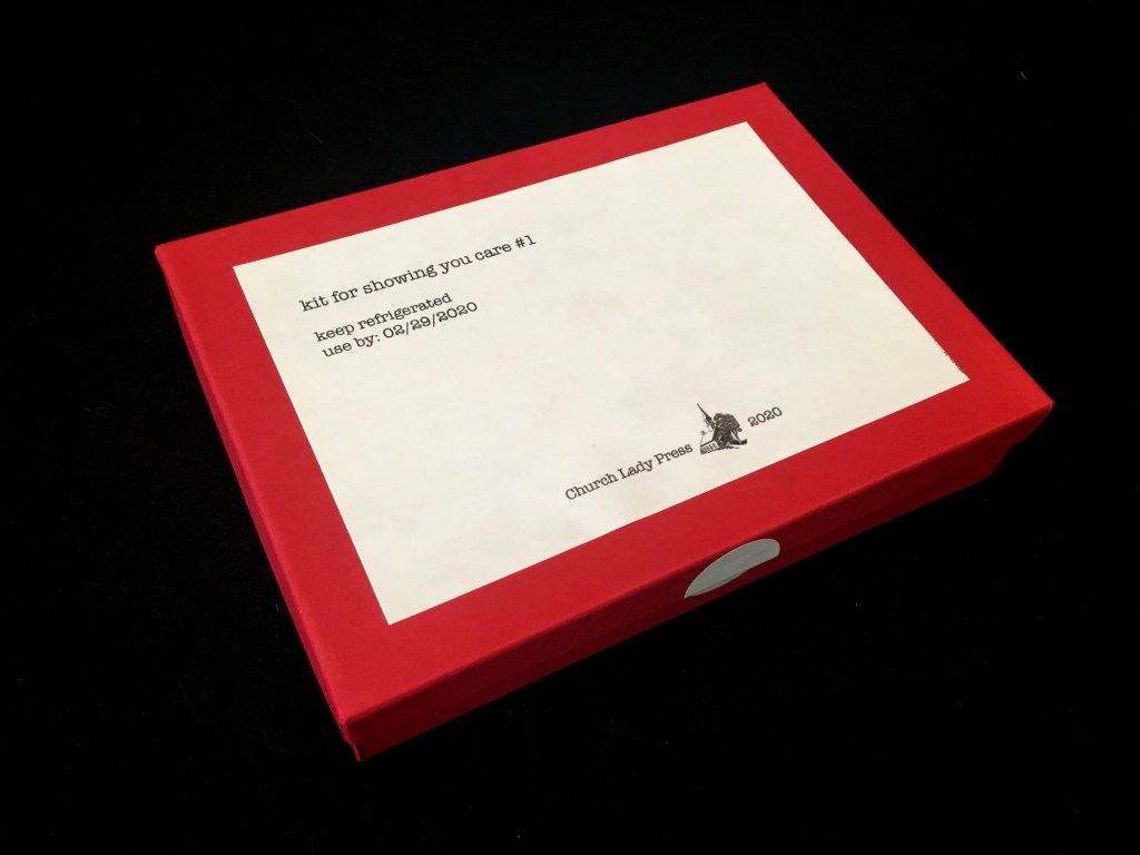 angled view of box which reads "kit for showing you care #1. keep refrigerated. use by: 02/29/2020. Church Lady Press. 2020."