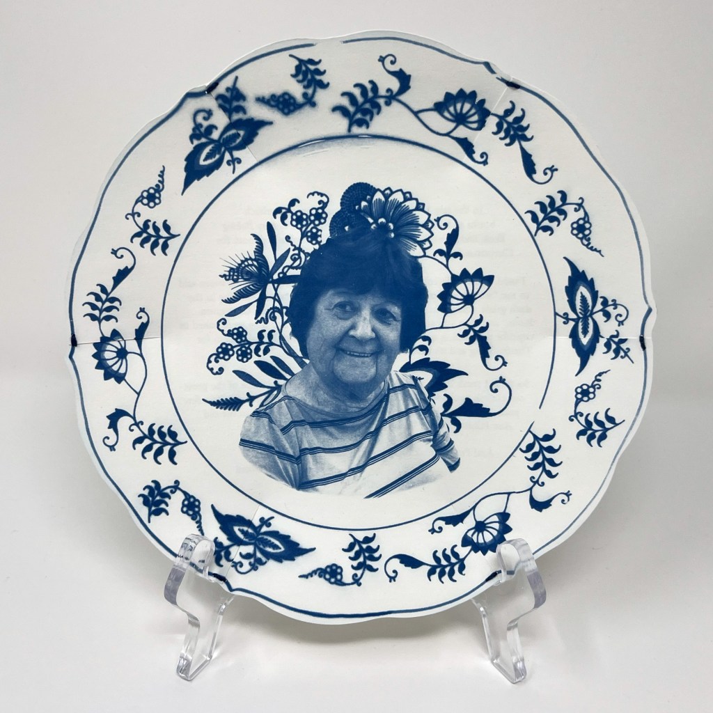 cyanotype printed plate in a blue and white china patter with a portrait of Barbara in the center